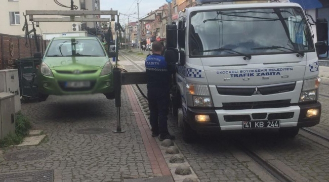 Tramvay yoluna park edilen araçlar çekiliyor